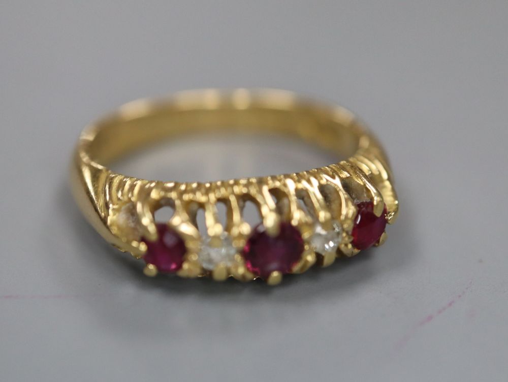 A late Victorian 18ct gold, ruby and diamond five stone ring, size I, gross 3.6 grams.